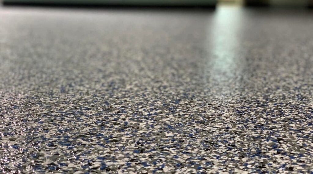 High-performance garage floor coating with polyurea base and flake finish